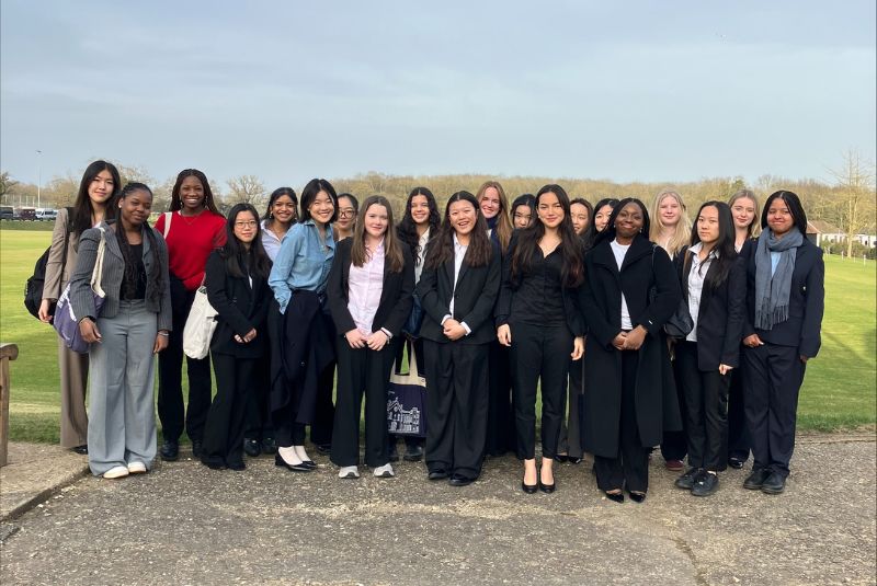 Wycombe Abbey pupils stood on Haileybury school field in their smart clothes.