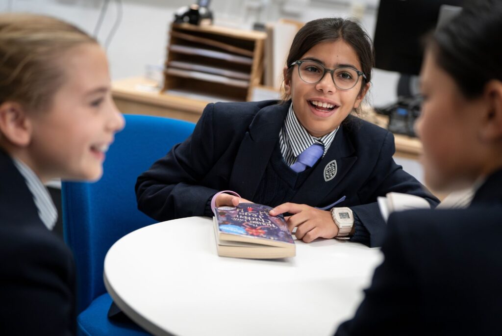 Pupils sat around a table having a discussion.